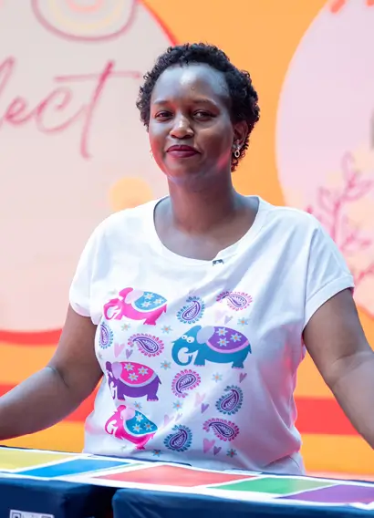 Lady in colorful T shirt posing at an event for charity organised by top event planner alice nakato